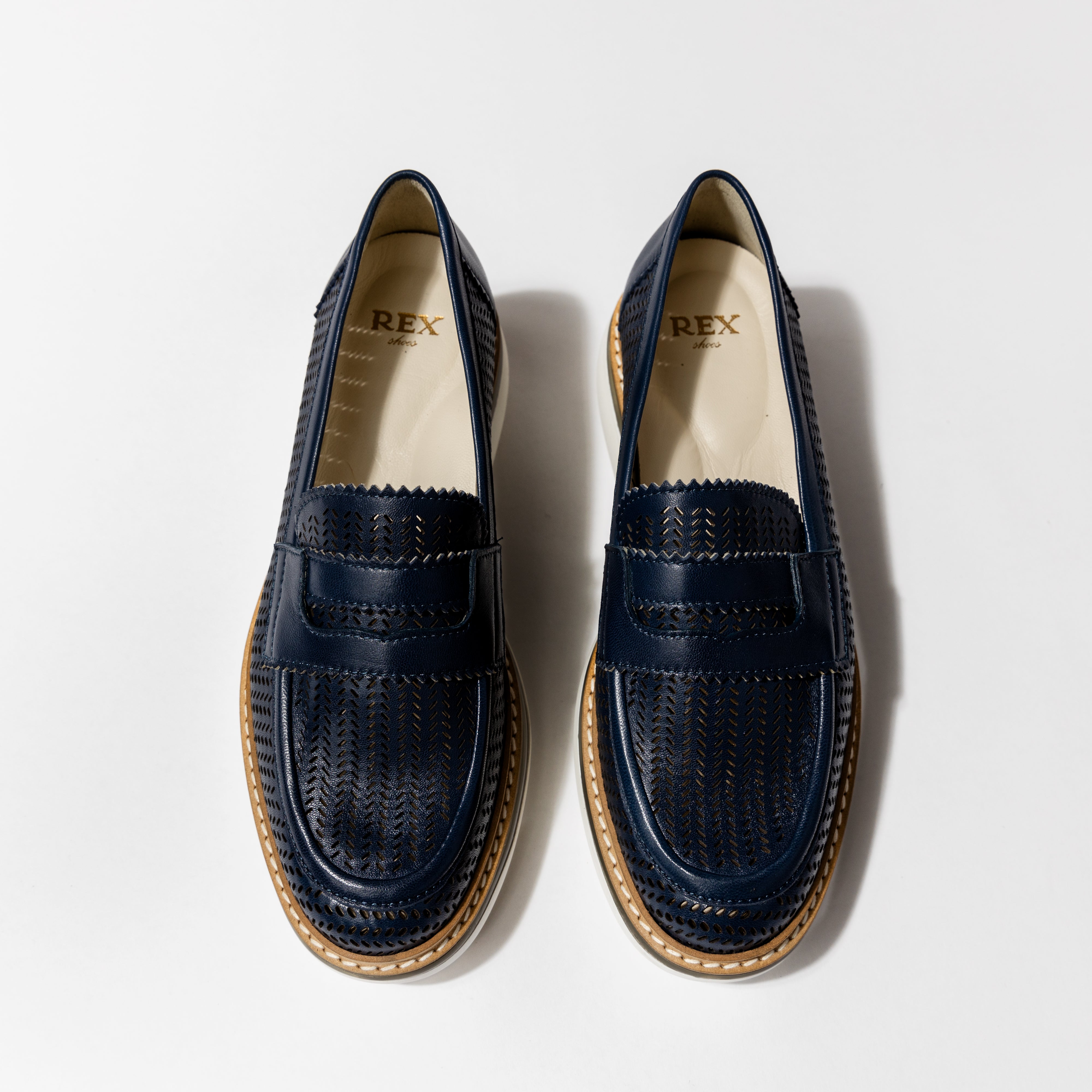 Top view of the &#39;Lauren&#39; luxury loafers in Nuit Leather, featuring sleek black perforated design and timeless strap detail, crafted by Rex Shoes.