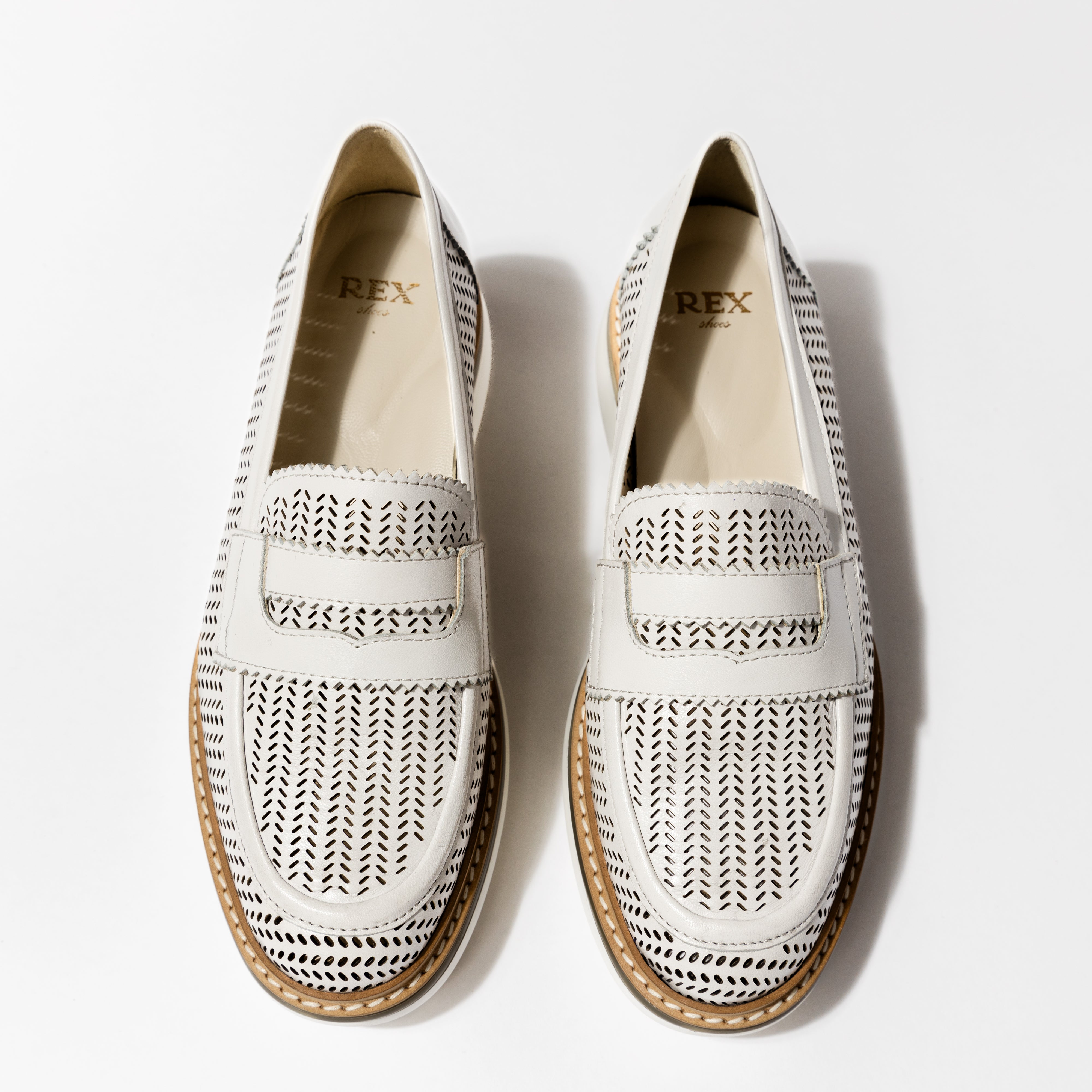 Overhead view of the &#39;Lauren&#39; luxury loafers in Panna Leather, displaying the pristine white perforated design and elegant strap detail, by Rex Shoes.