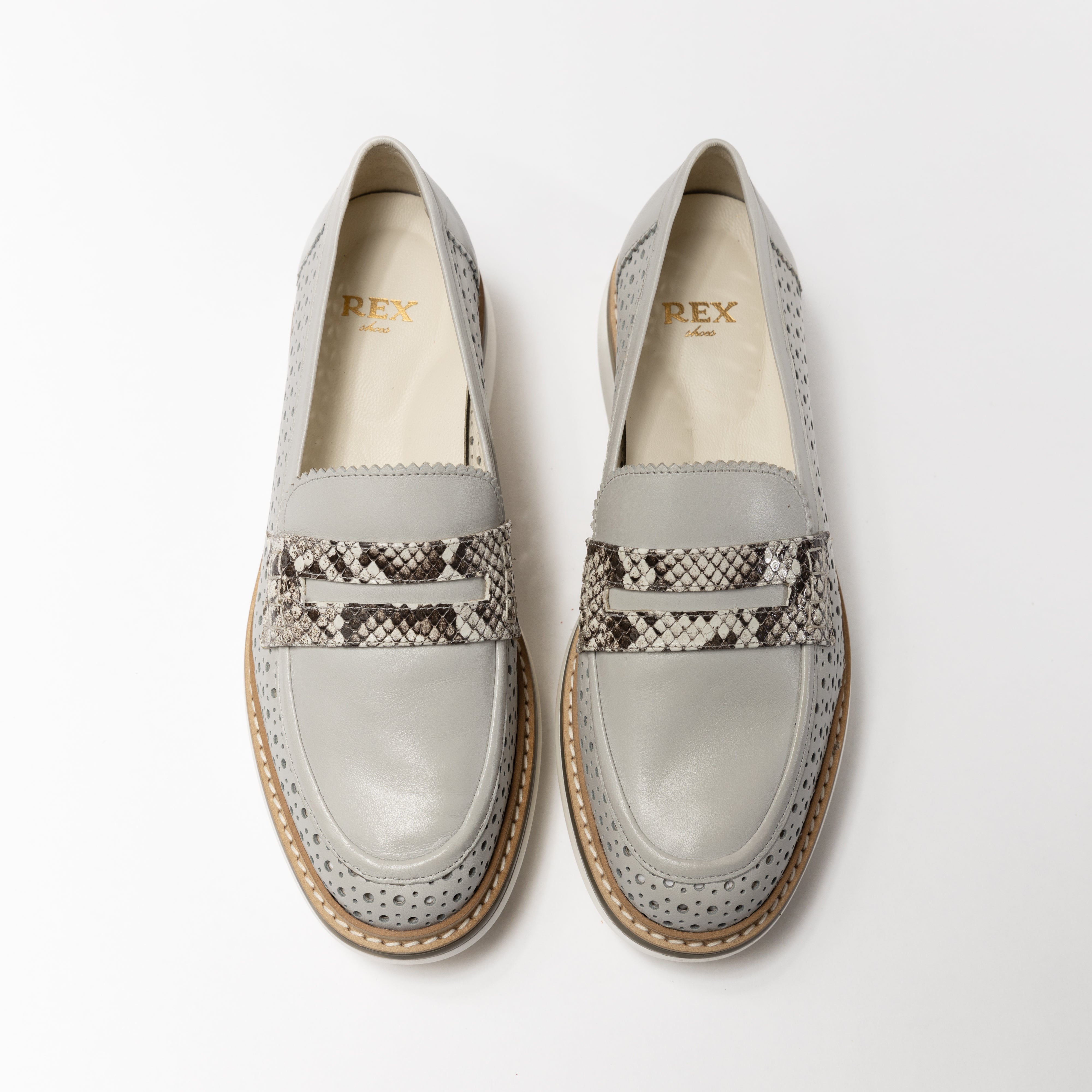 Top view of the Rex x Inversa Marcie Loafer in perforated lambskin with a distinctive non-perforated vamp, accented by a unique Inversa python penny strap, complete with a single light brown natural salpa welt and a lightweight TPU outsole, all handcrafted in Spain.