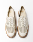 Top-down view of the 'Liz' Oxford shoes in Panna Leather, showcasing a crisp white perforated upper and lace-up design, with a classic brown welt and white sole.